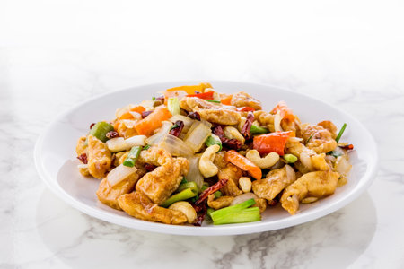 Stir fried Chicken with cashew nuts on bright marble backgroundの写真素材