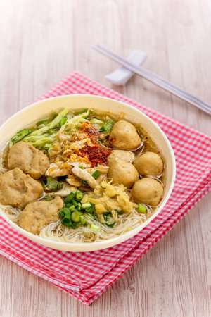 Noodle soup with pork balls on wooden backgroundの写真素材