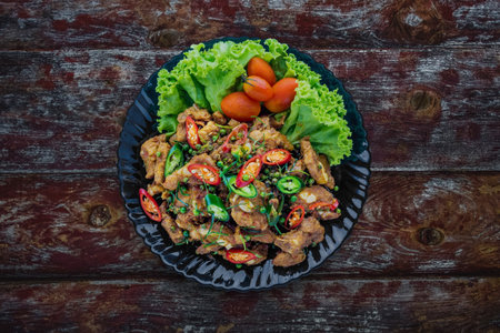 Spicy stir fried Pork Ribs on dark wooden backgroundの写真素材