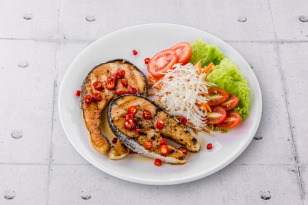 Salmon steak with sauce on metal backgroundの写真素材