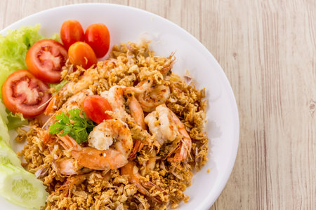 Fried shrimp with garlic and pepper on wooden backgroundの写真素材