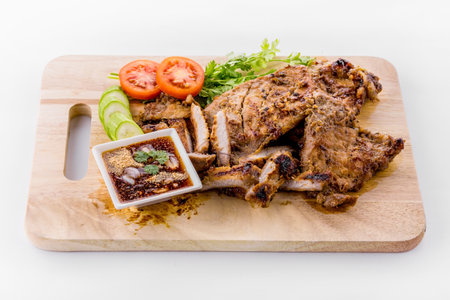 Thai grilled pork neck with spicy dipping sauce on white backgroundの写真素材