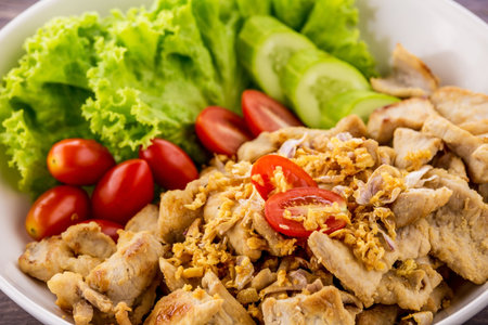 Stir fried chicken with garlic on dark wooden backgroundの写真素材