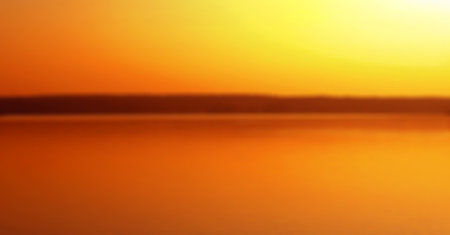 very blurred background, orange sunset reflecting in the water