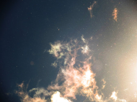 Abstract background with floating dust and garnish with translucent cloudsの写真素材