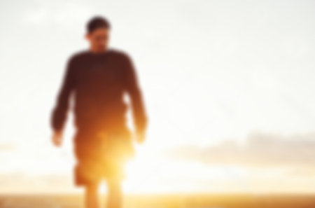 Blurred man on the summer beach at sunriseの写真素材