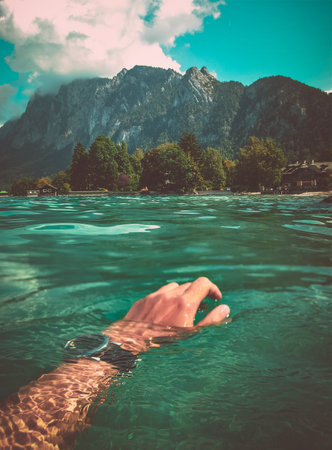 swimming in the lake and view of the high mountains in the Austrian Alps