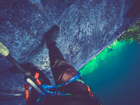 Climber reaches the summit of a mountain, Via ferrata, ferrate brake in engagementの写真素材