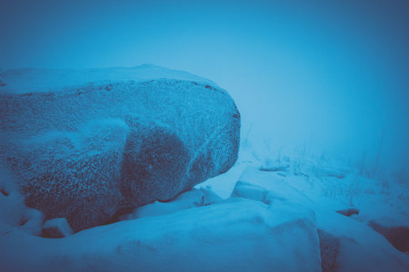 winter landscape in the mountains in bad weather, fog, darknessの写真素材