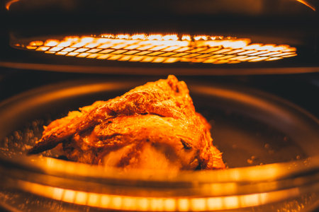 the closeup chicken grilling on electric heat grill, golden colorの写真素材