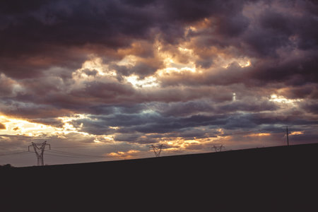the dramatic sky at sunset over the fieldの写真素材