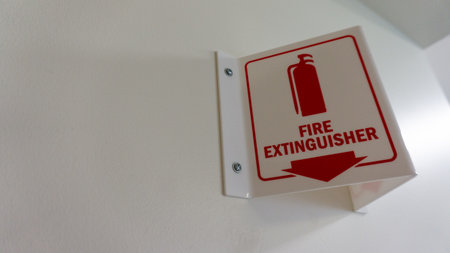 A fire extinguisher indicator sign on the wallの写真素材