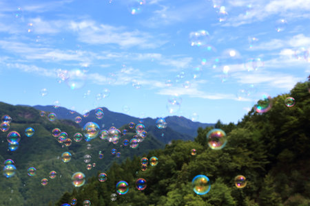 Soap bubbles floating in a blue sky