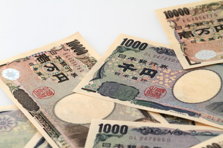 Japanese Yen bills on white backgroundの写真素材
