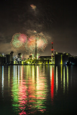 Factory night view and fireworks in Tsukumi City, Oita Prefectureの写真素材