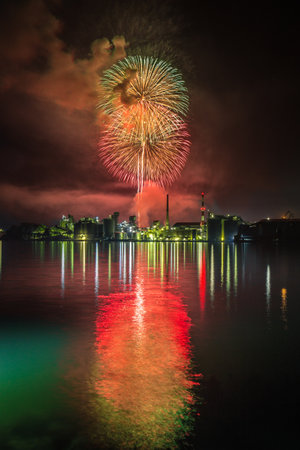 Factory night view and fireworks in Tsukumi City, Oita Prefectureの写真素材