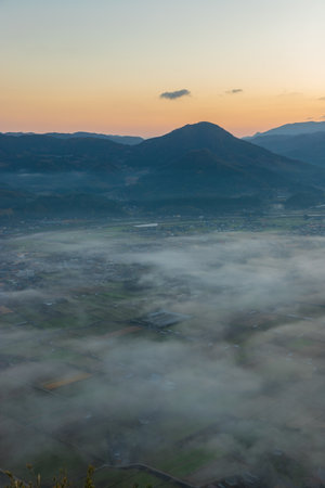Aerial view of foggy morning in the mountains. Landscape with fog in the valley.の写真素材