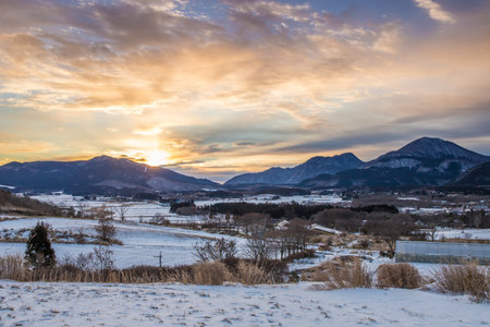 Beautiful winter landscape and dawn with snow-capped mountains in the backgroundの写真素材