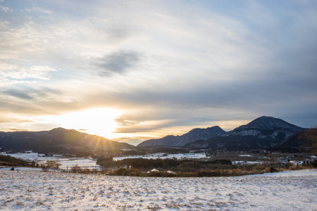 Beautiful winter landscape and dawn with snow-capped mountains in the backgroundの写真素材