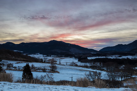 Beautiful winter landscape and dawn with snow-capped mountains in the backgroundの写真素材