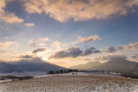 Beautiful winter landscape and dawn with snow-capped mountains in the backgroundの写真素材