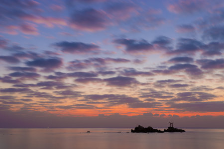 Silhouette of a structure on the island in the sea at sunsetの写真素材