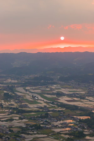 Sunset and rice fields from the summitの写真素材
