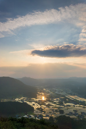 Sunset and rice fields from the summitの写真素材
