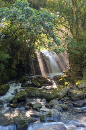 Waterfall and rays of lightの写真素材