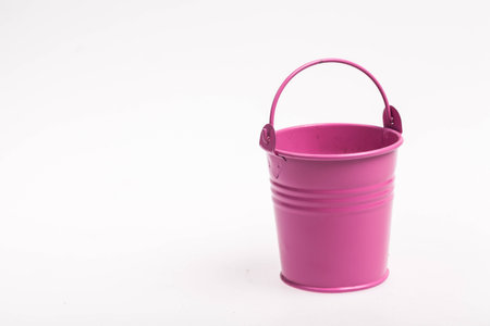 small bucket-style pink vase for flower on white background.の写真素材
