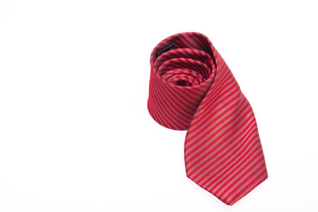 red business neck tie silk rolled on white background.の写真素材
