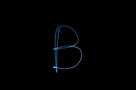 Long exposure small neon lights letter B texture. Abstract colourfull neon light.の写真素材