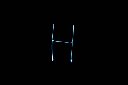 Long exposure small neon lights letter H texture. Abstract colourfull neon light.の写真素材