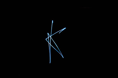 Long exposure small neon lights letter K texture. Abstract colourfull neon light.の写真素材