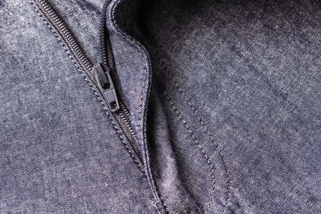 zipper of gray color pants background.