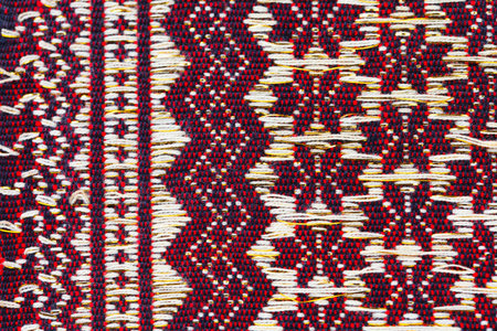 Red thai silk fabric pattern background. Old handmade.の写真素材