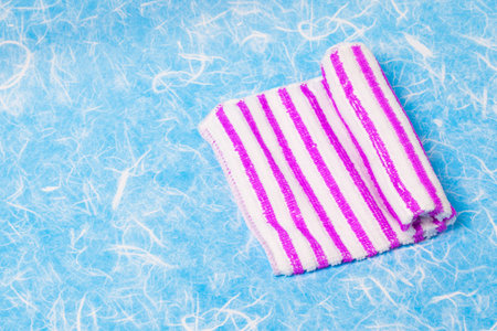 Roll napkin fabric hand on background.の写真素材