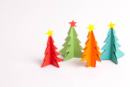 Origami Christmas tree paper color on white background.
