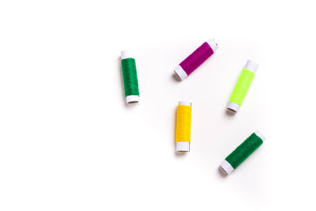 Multicolor sewing threads on white background.