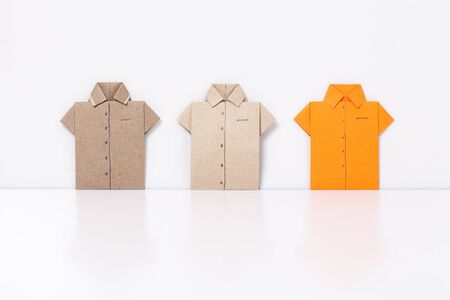 origami a man's shirt on a white background orange brown of paperの写真素材