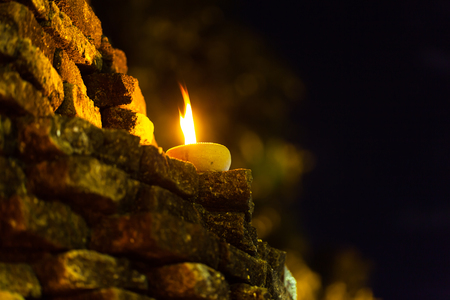 Still life candle light on old wall wiht Loy Krathong festival.の写真素材