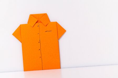 origami a man's shirt on a white background orange of paperの写真素材