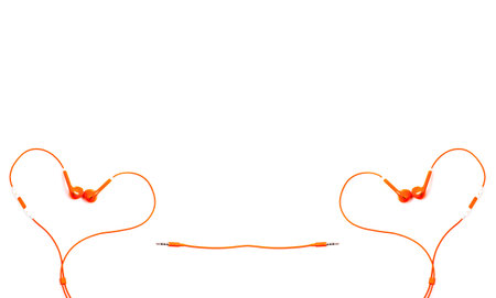 Orange color earphone on background.