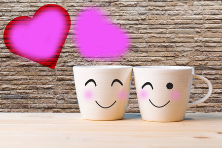 Two happy cups on the wood table with glass surface windows. love concept in rain season.の写真素材