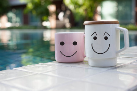 two cups smile at pool.の写真素材