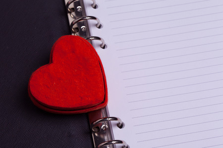 Red heart box in leather book.の写真素材