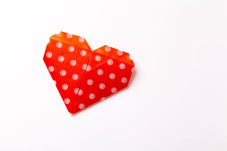 Origami red heart paper on white background.の写真素材