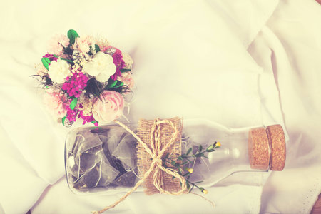 Tea bag in a glass jar with flower.の写真素材