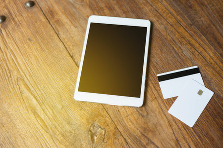 Tablet and blank creditcart on wood table.の写真素材