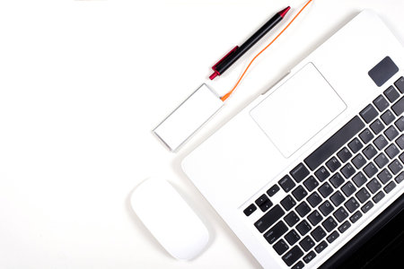 Orange and red color earphone with laptop on white background.の写真素材